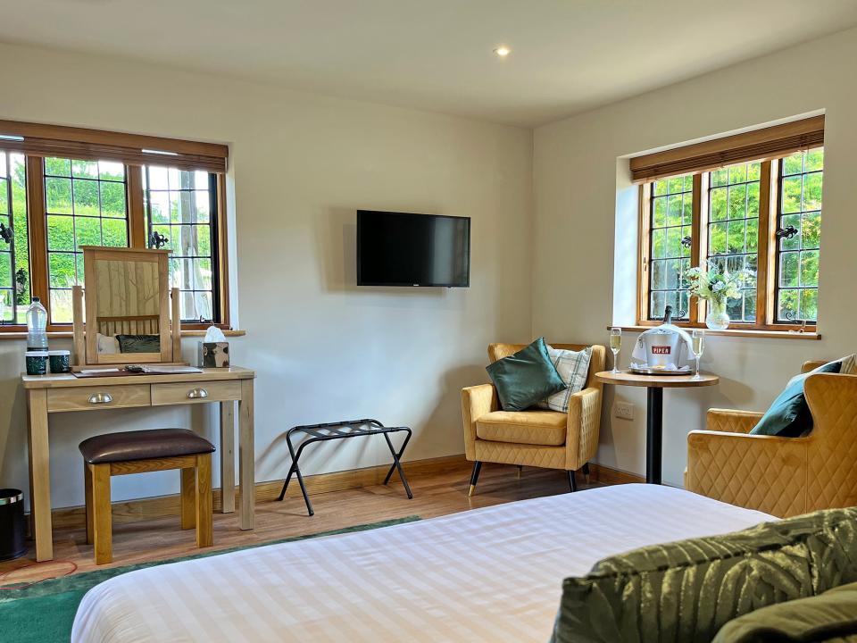 Spacious bedroom with greenery in windows